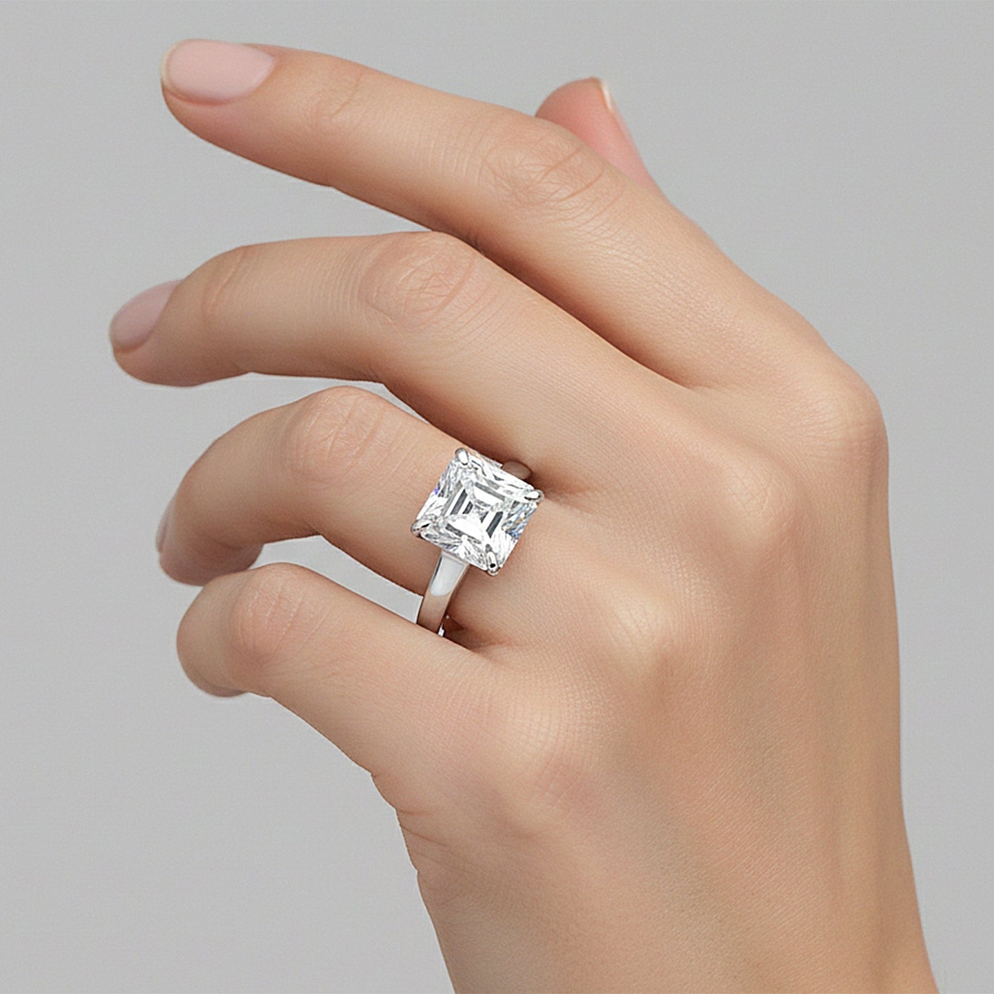 Asscher cut lab diamond ring worn on hand, art deco engagement styling