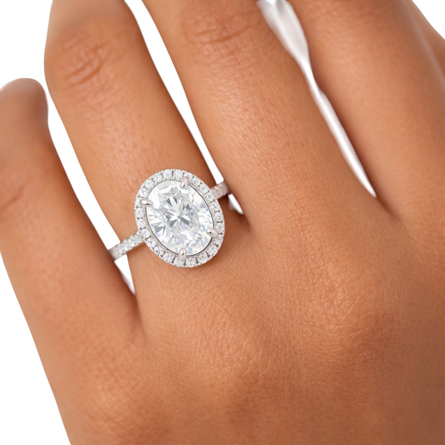 GEMHUB & CO. 3.00 Ct oval cut lab grown diamond ring with VS1 clarity, set in 18k gold vermeil with a halo of smaller diamonds.