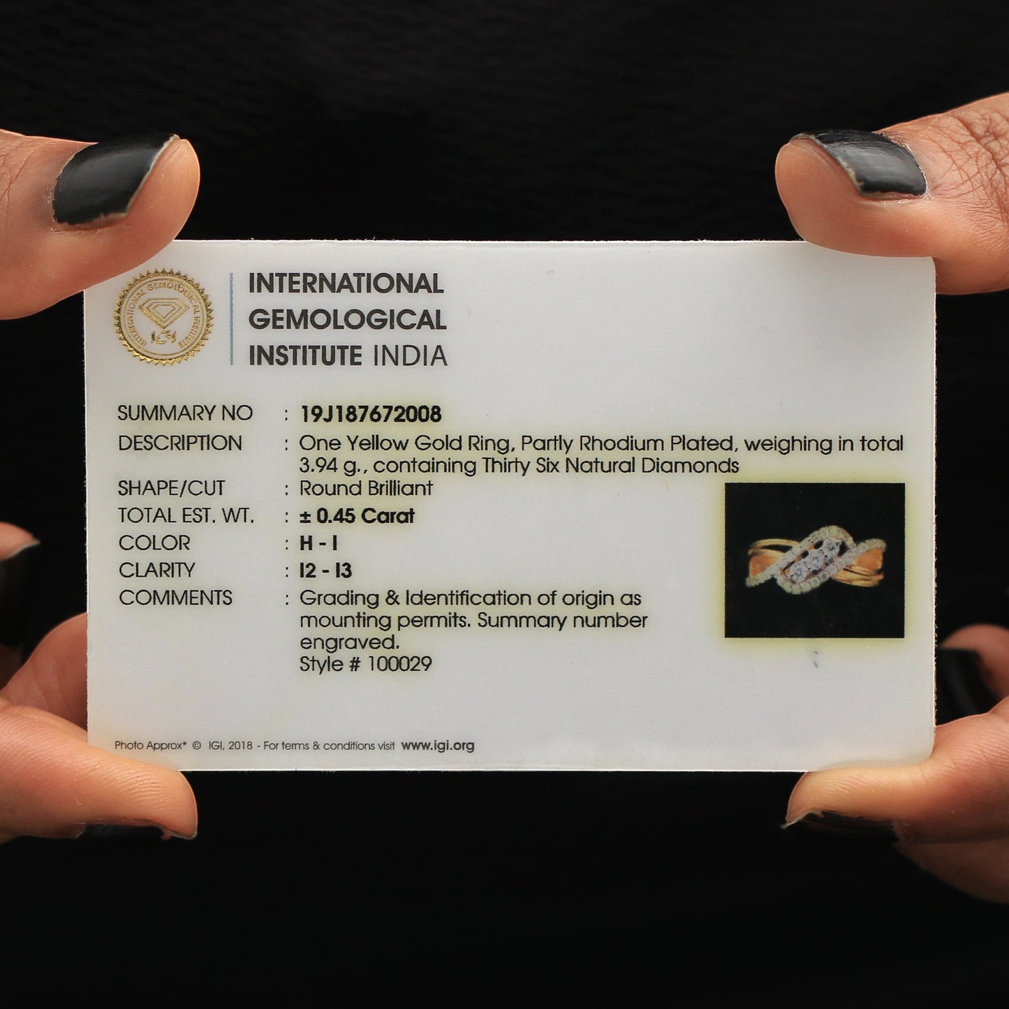 18k yellow gold criss-cross ring shown alongside IGI certificate card
