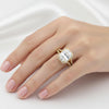 Side profile of 5 carat emerald diamond ring on yellow gold vermeil shoulders