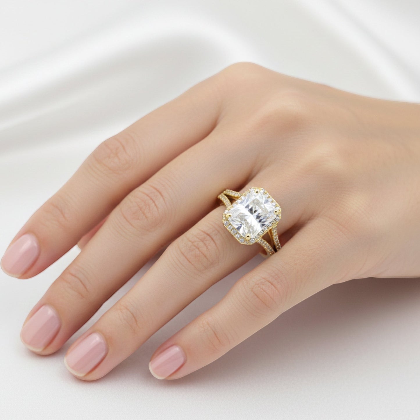 Side profile of 5 carat emerald diamond ring on yellow gold vermeil shoulders