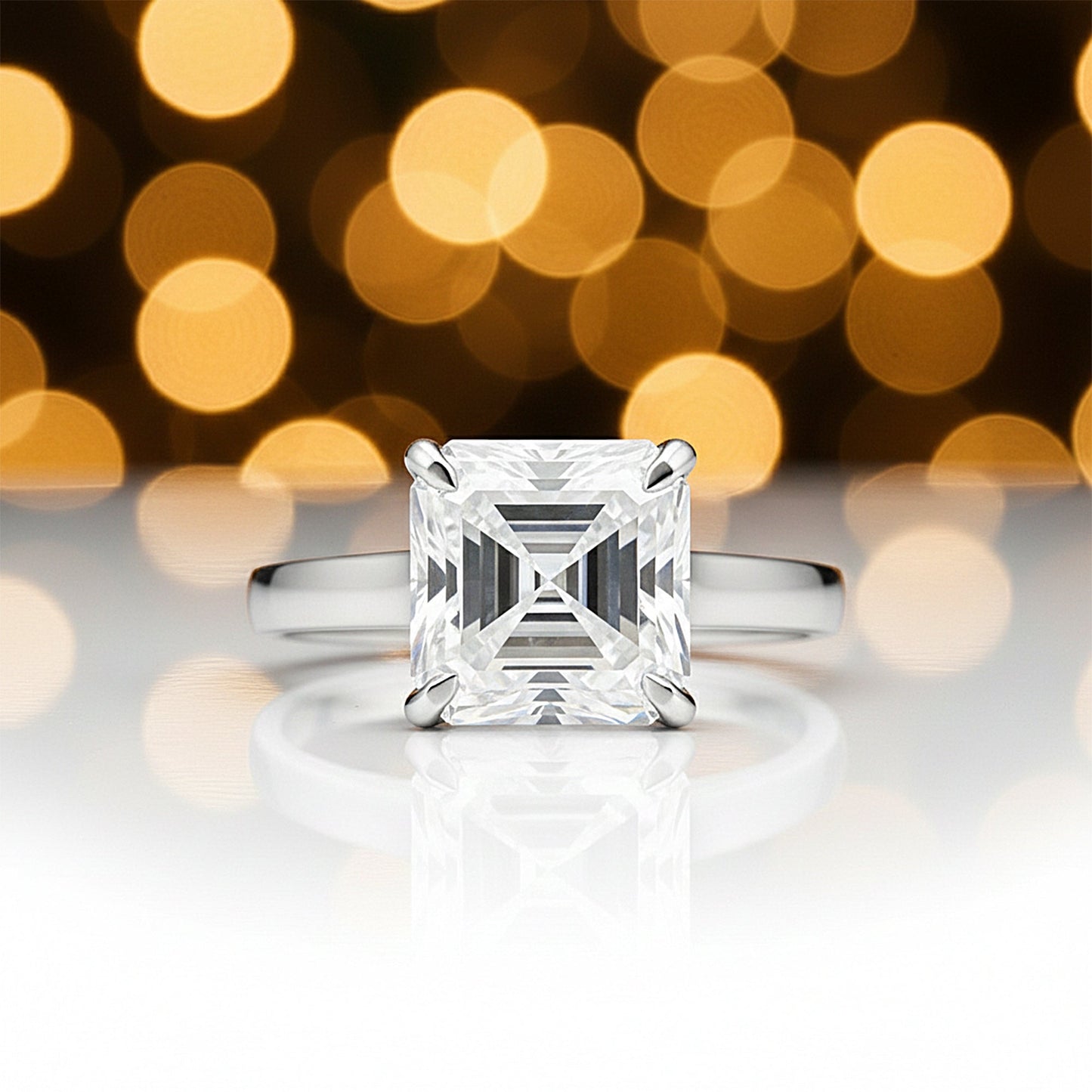 Detail of 18k gold vermeil prongs holding asscher cut lab diamond, top-down