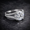 Round lab diamond solitaire with pavé shoulders on dark background, full fire