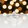 Detail of 18k gold vermeil prong holding tip of pear-cut diamond