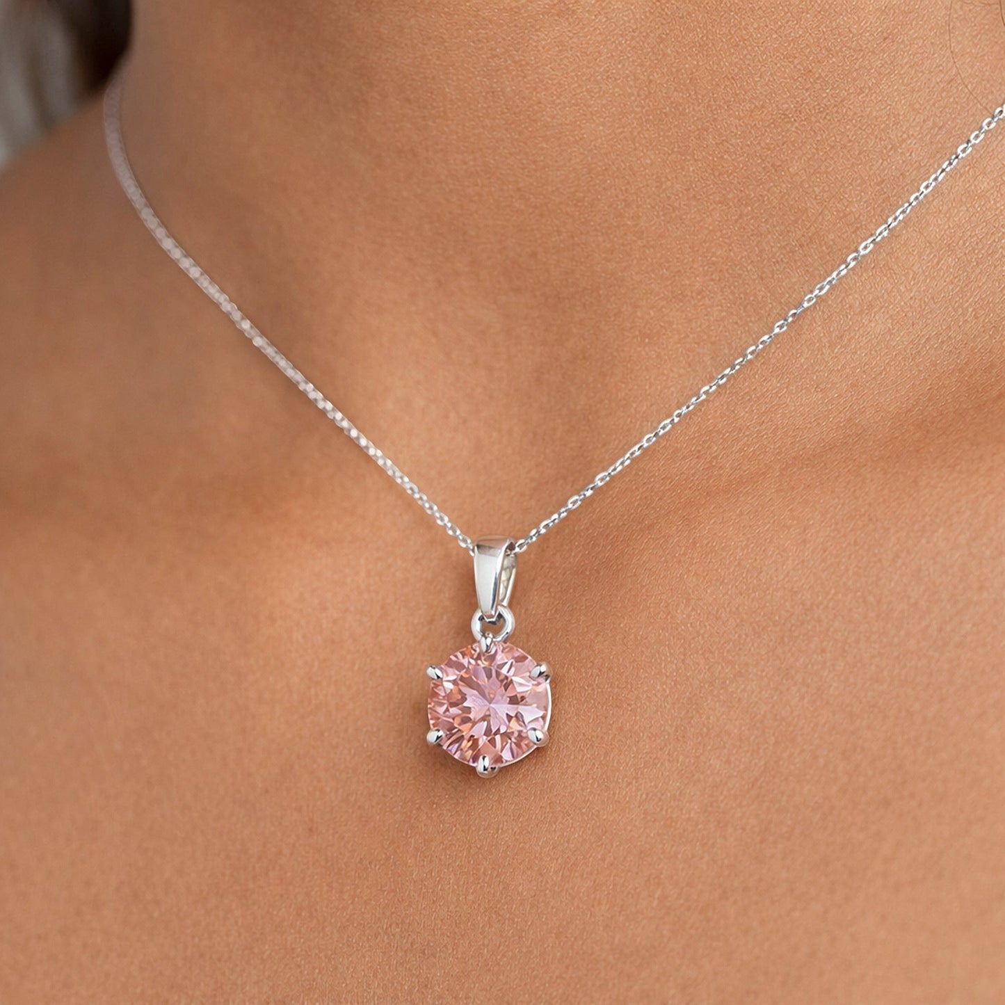 Round-cut pink lab diamond pendant with detailed view of 4-prong vermeil mounting
