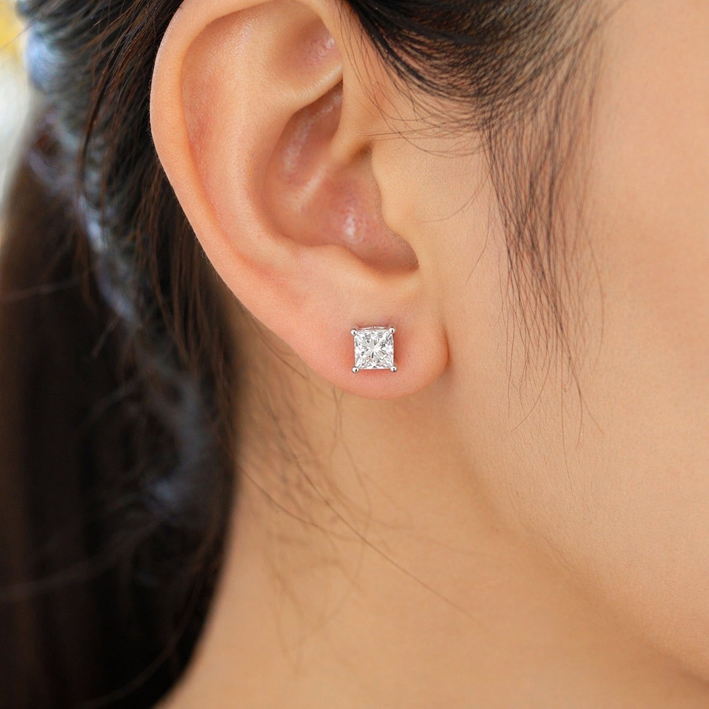 Side profile of 4ct princess diamond earring with platinum four-prong setting