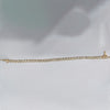 Underside of bezel tennis bracelet showing 14k yellow gold hallmark