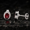 Side angle of garnet drop earring showing sterling silver wire and bezel