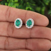 Green emerald cut earrings worn on ear, evening jewellery styling