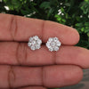 White topaz stud earrings worn on ear, diamond-alternative styling