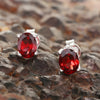 Close-up of single garnet earring showing facets and rich pomegranate hue