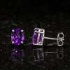 Side view of single amethyst earring with sterling silver wire detail
