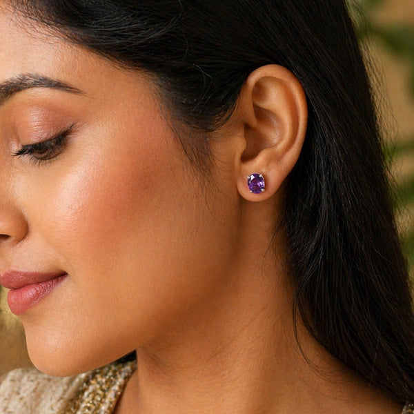Pair of amethyst drop earrings showing rich violet colour and oval brilliant cut
