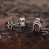 Close-up of oval-cut natural red garnet, gemmological clarity grade