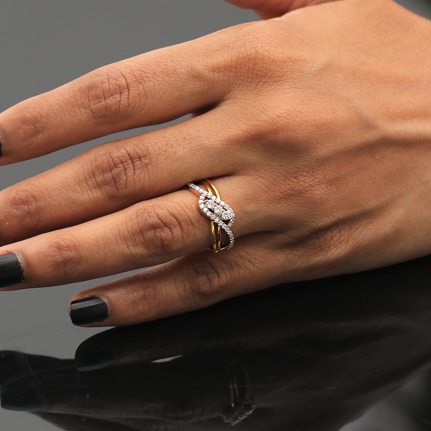 Detail of small round brilliant diamonds set in woven yellow gold band