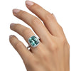 GEMHUB & CO. 5.00 Ct cushion cut blue lab grown diamond ring with VS1 clarity, set in 18k gold vermeil with a halo of smaller diamonds.