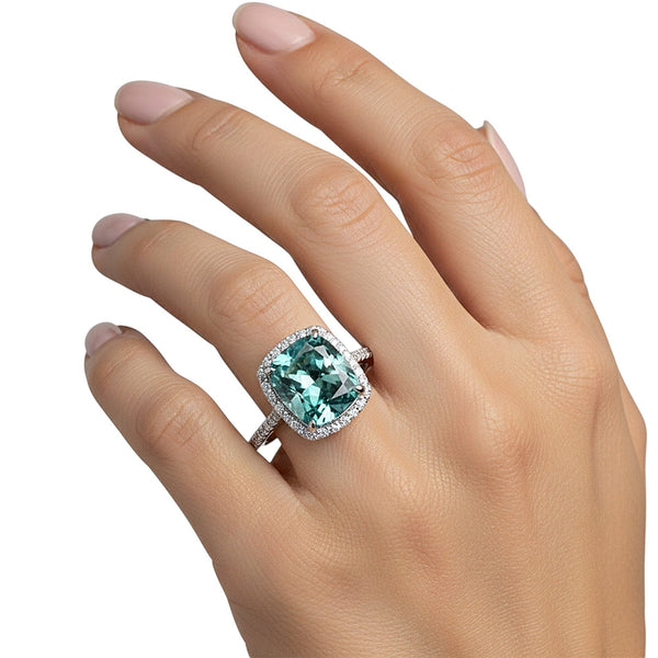 GEMHUB & CO. 5.00 Ct cushion cut blue lab grown diamond ring with VS1 clarity, set in 18k gold vermeil with a halo of smaller diamonds.
