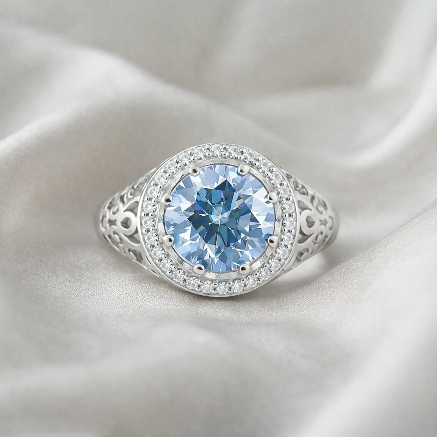 GEMHUB & CO. 3.50 Ct round cut blue lab-grown diamond ring with VS1 clarity, set in 18k gold vermeil with a halo of smaller stones.