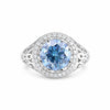 GEMHUB & CO. 3.50 Ct round cut blue lab grown diamond ring with VS1 clarity, set in 18k gold vermeil with a halo of small white diamonds.