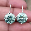 GEMHUB & CO. 6.20 Ct round blue moissanite dangler earrings in 18K gold vermeil over 925 sterling silver.