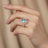GEMHUB & CO. 4.70 Ct blue pear cut moissanite solitaire ring with diamond halo and band, set in gold vermeil.