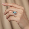 GEMHUB & CO. 4.70 Ct blue pear cut moissanite solitaire ring with diamond halo and band, set in gold vermeil.