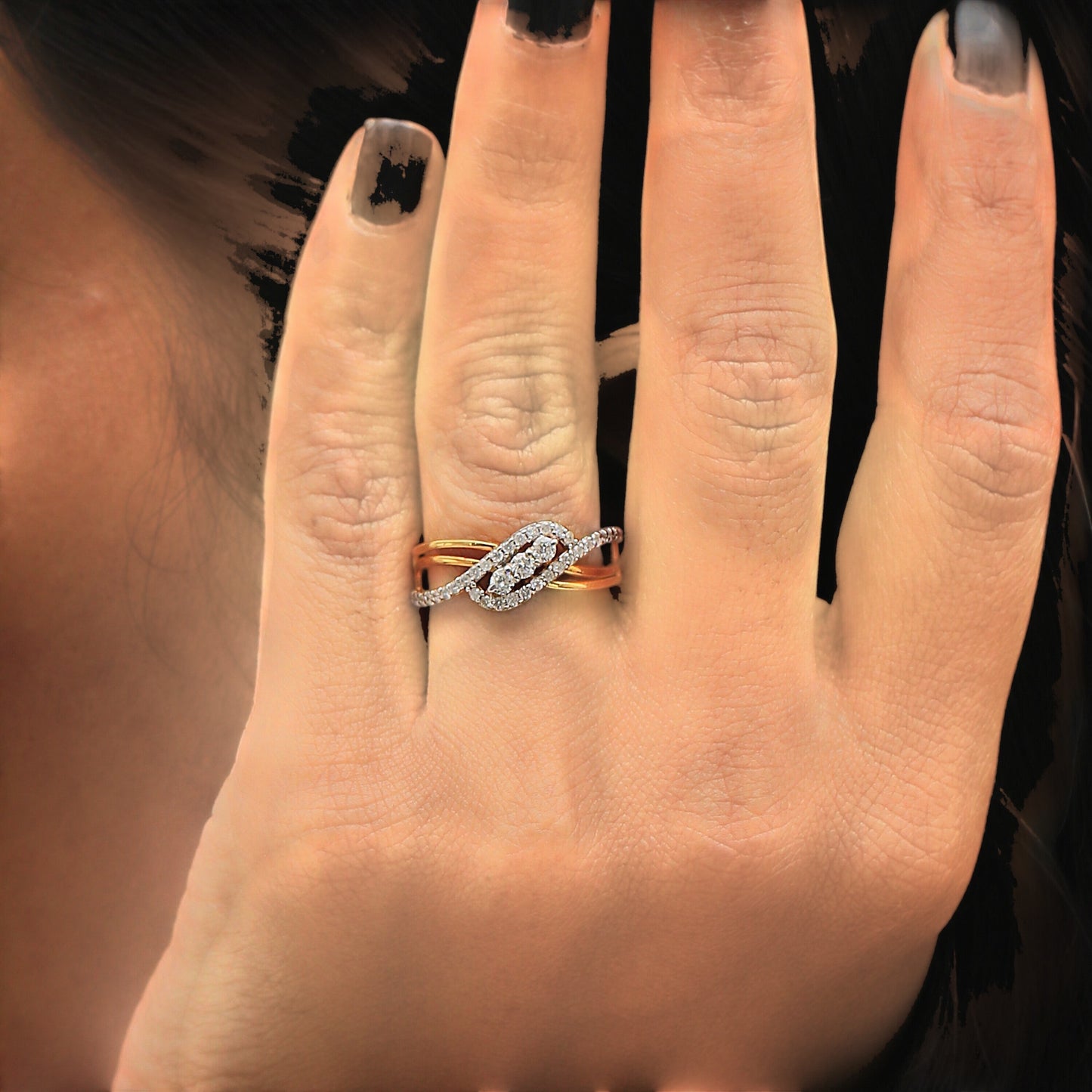 Side profile of 18k yellow gold diamond ring with criss-cross overlap detail