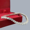 Top view of luxurious diamond tennis bracelet showing prong setting and fire