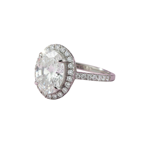 GEMHUB & CO. 3.00 Ct oval cut lab grown diamond ring with VS1 clarity, set in 18k gold vermeil with a halo of smaller diamonds.