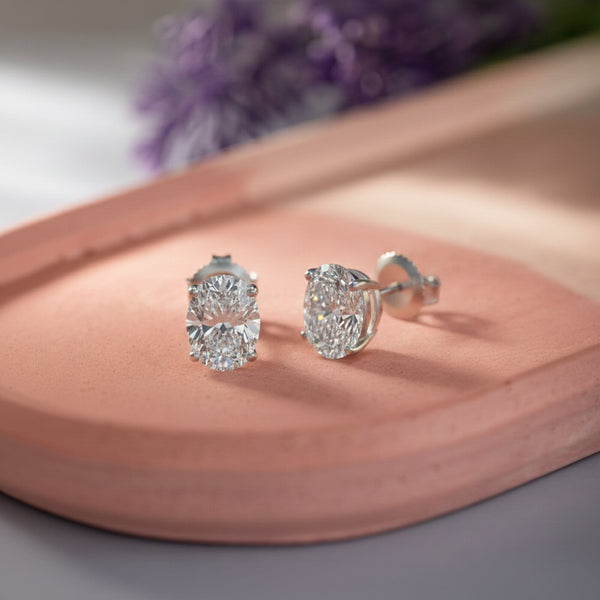GEMHUB & CO. pair of oval lab-created diamond stud earrings in 950 platinum with screw backs.