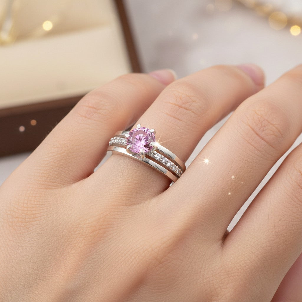 GEMHUB & CO. 18K gold plated vermeil ring with a 1.35ct round pink moissanite center stone and channel-set accent stones.