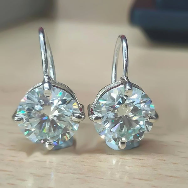 GEMHUB & CO. 10 Ct round cut white moissanite dangler earrings in 18K gold vermeil over 925 sterling silver.
