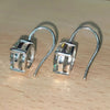 GEMHUB & CO. 10 Ct round cut white moissanite dangler earrings in 18K gold vermeil over 925 sterling silver.