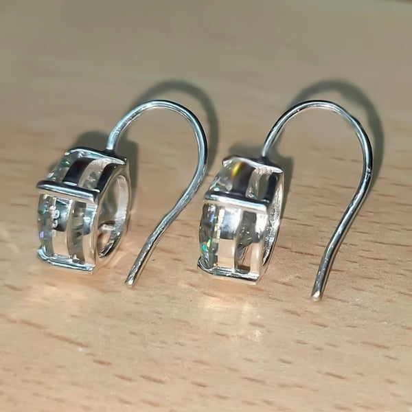 GEMHUB & CO. 10 Ct round cut white moissanite dangler earrings in 18K gold vermeil over 925 sterling silver.