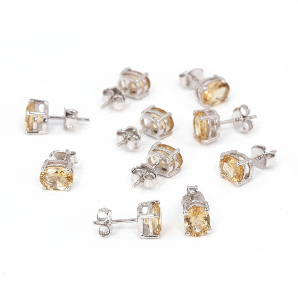 GEMHUB & CO. lot of 5 pairs of oval yellow citrine stud earrings in 925 sterling silver.