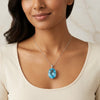 GEMHUB model-wearing (AI) – 135 ct Natural Blue Topaz Oval Pendant in 925 Sterling Silver, shown on a chain (chain not included)